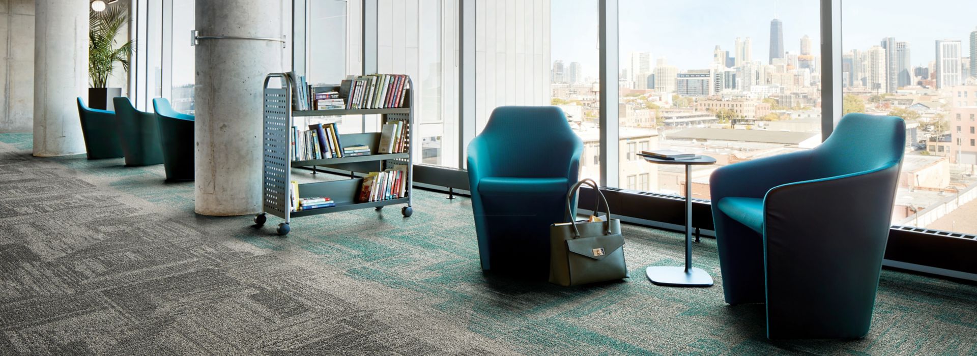 Interface Open Air 403 carpet tile in library with cement columns and city skyline in background through windows