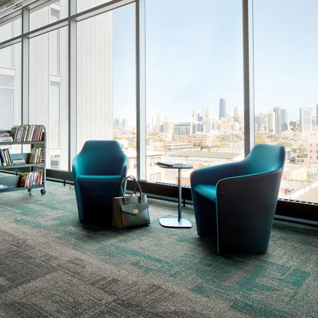 Interface Open Air 403 carpet tile in library with cement columns and city skyline in background through windows