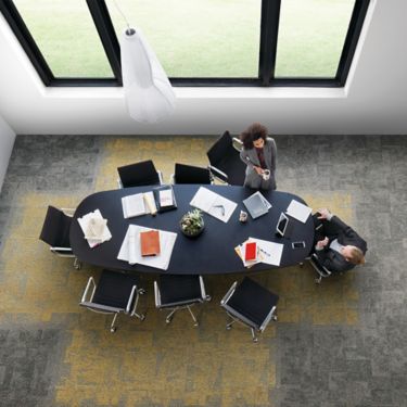 Interface Open Air 404 carpet tile in overhead view of meeting table with man and woman talking and drinking coffee image number 1