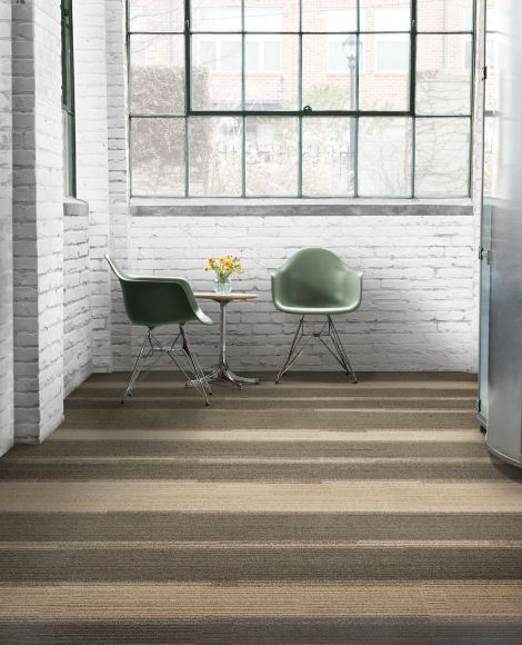 Interface Off Line plank carpet tile with corner table and flowers on table