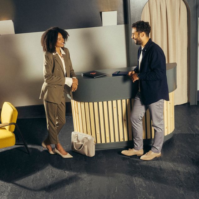 norament 926 arago rubber flooring with people talking in corporate lobby