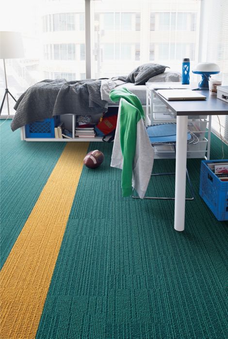 Interface On Line plank carpet tile in dorm room with football on floor