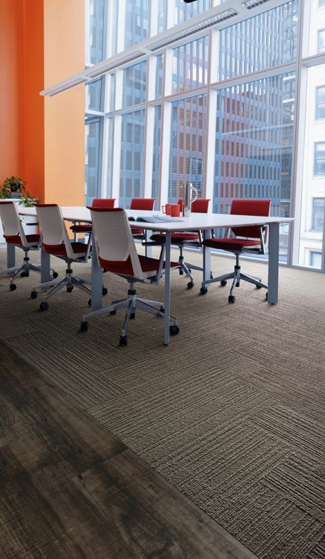 Interface On Line plank carpet tile in meeting room with orange wall and red chairs
