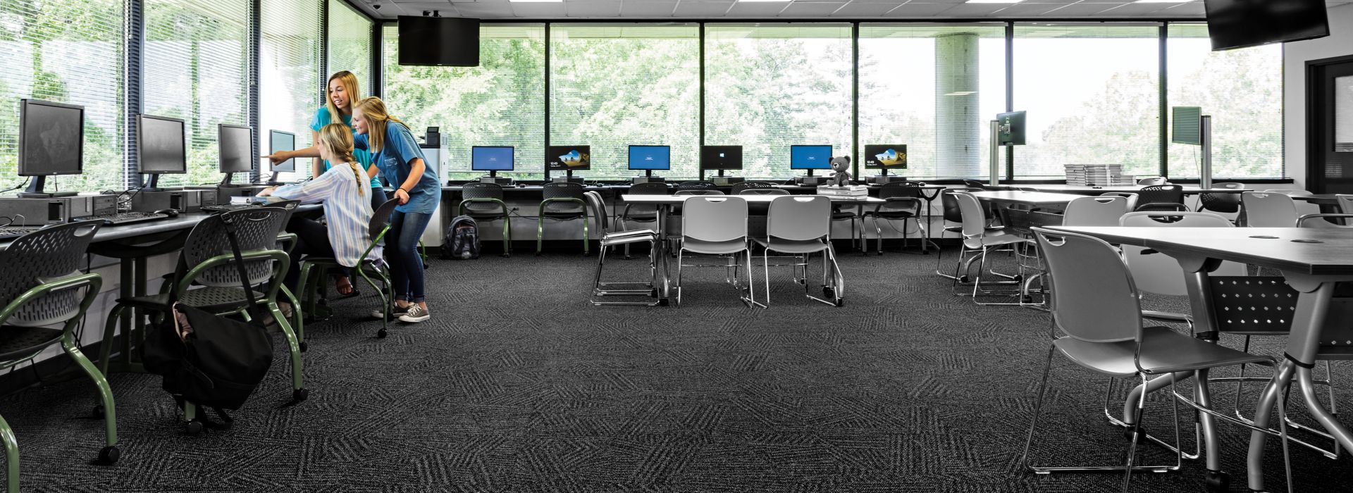 Interface Open Air 412 carpet tile in open workspace with women collaborating around computer