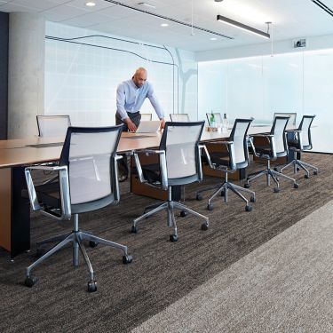 Interface Open Air 402 plank carpet tile with man working on laptop at conference table image number 1