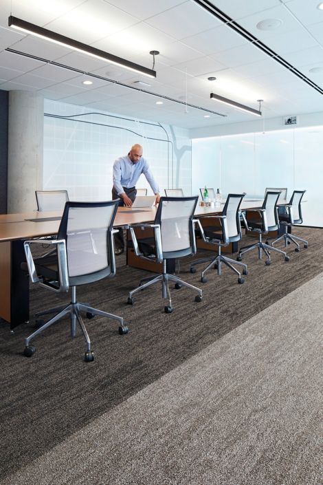 Interface Open Air 402 plank carpet tile with man working on laptop at conference table image number 3