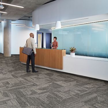 Interface Open Air 403 carpet tile in front desk area with man speaking with woman image number 2