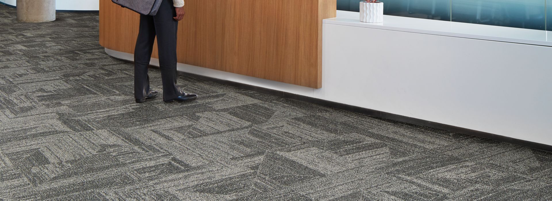 Interface Open Air 403 carpet tile in front desk area with man speaking with woman