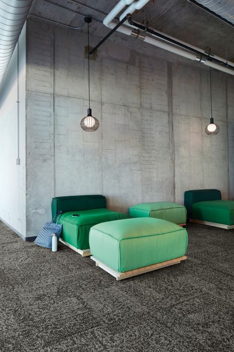 Interface Open Air 405 carpet tile with cement wall and green puffy chairs and ottomans