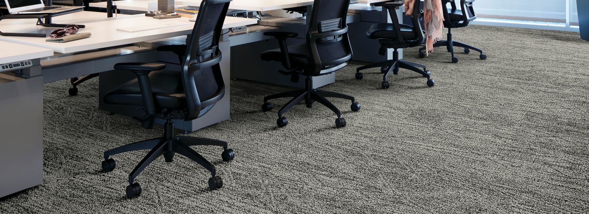 Interface Open Air 409 plank carpet tile with open work stations and cardigan draped over office chair