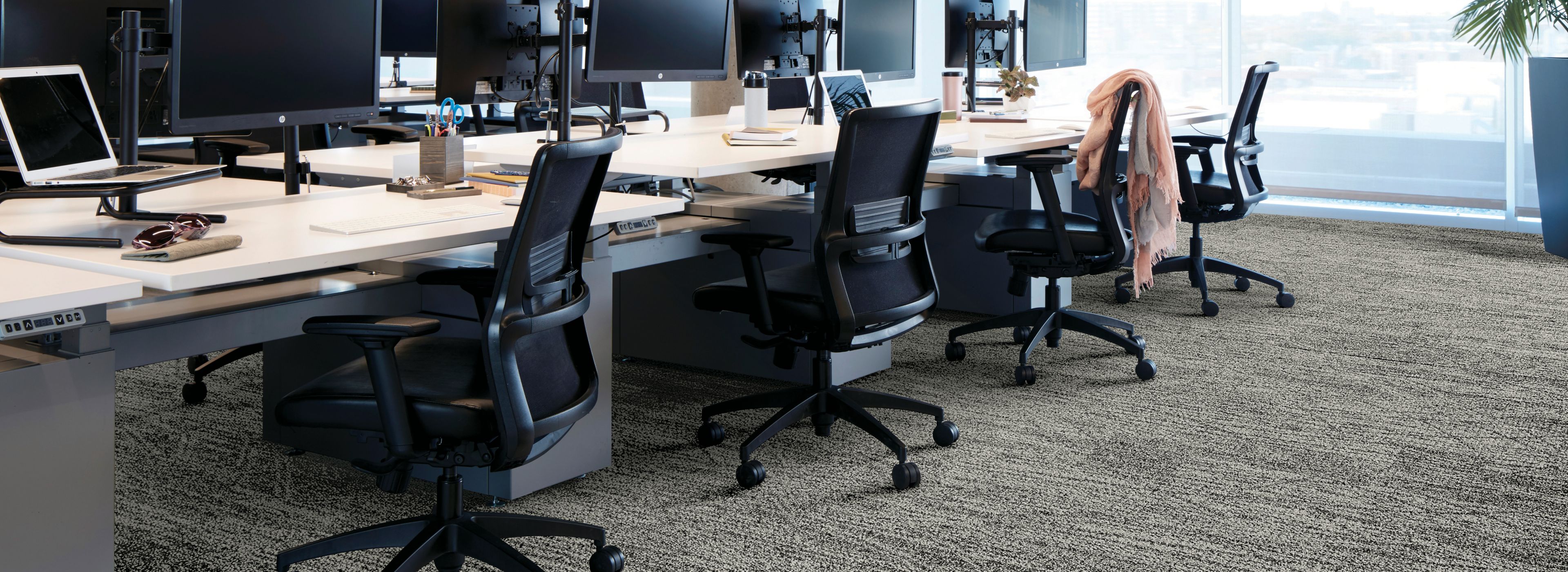 Interface Open Air 409 plank carpet tile with open work stations and cardigan draped over office chair image number 1