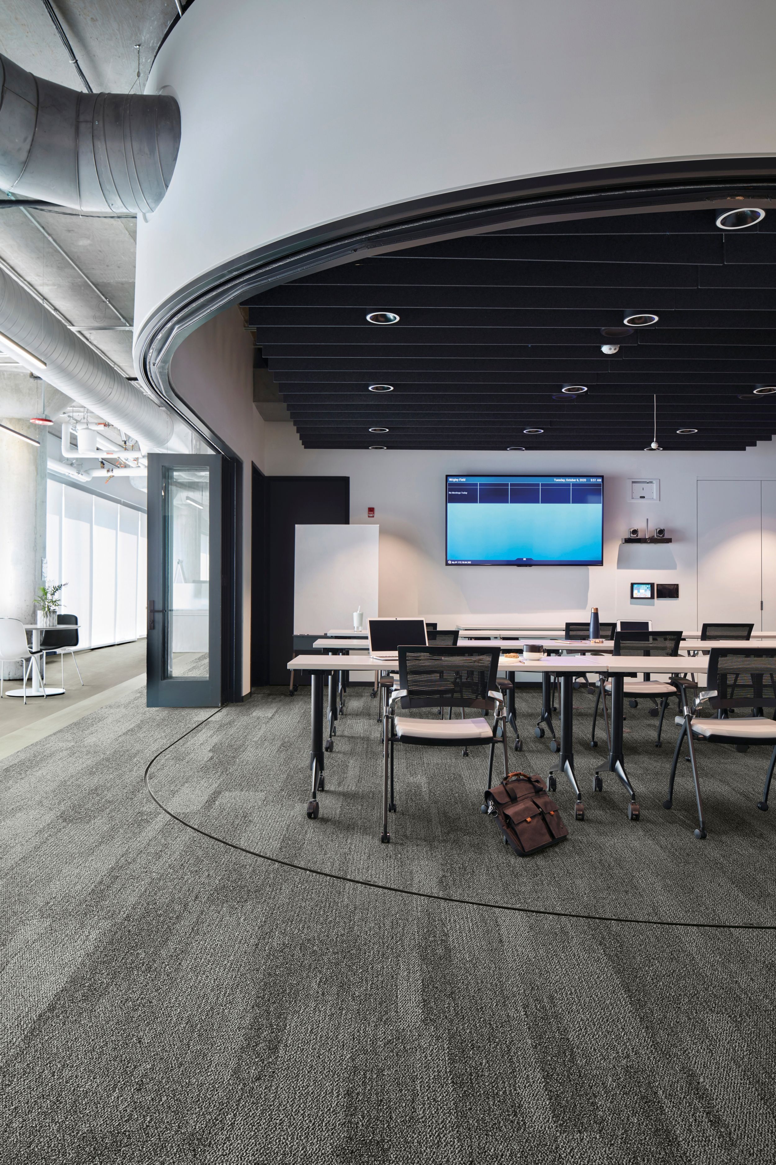 Interface Open Air 410 plank carpet tile in open conference room with satchel leaning on chair image number 1