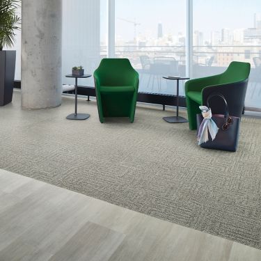 Interface Open Air 413 carpet tile in lounge space with green chairs and cement column