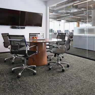 Interface Open Air 421 carpet tile in meeting room with wood conference table and glass doorway