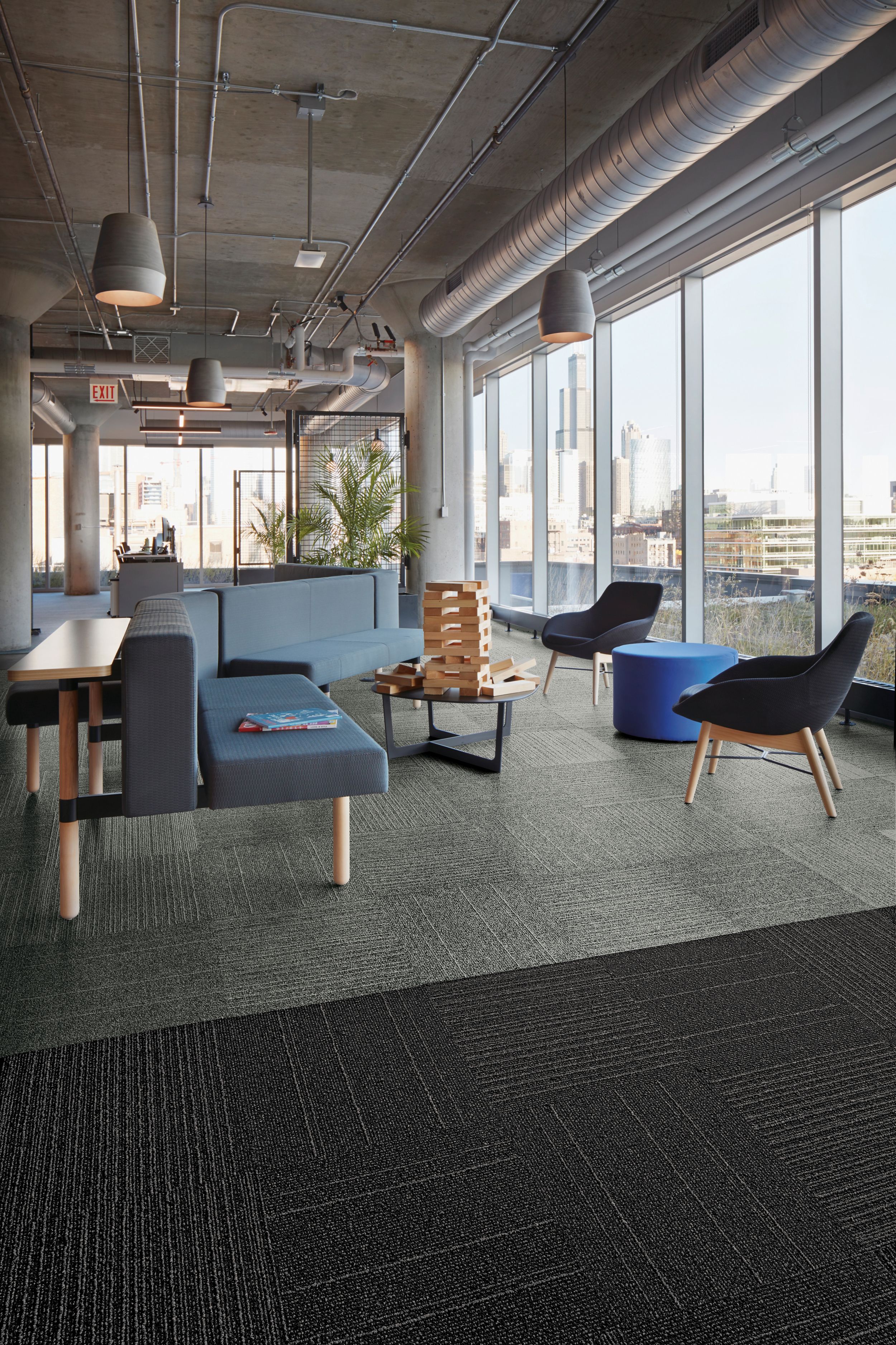 Interface Open Air 423 carpet tile in social space with blue seating and floor to ceiling windows image number 1