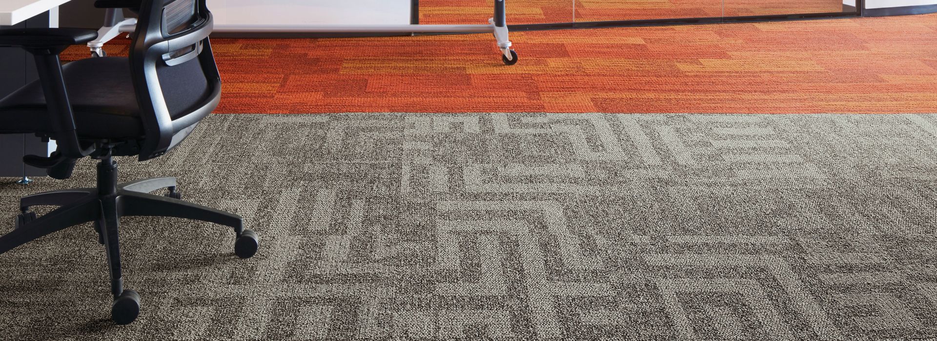 Interface Open Air 414 carpet tile with AE317 plank carpet tile in corner workstation with whiteboard and meeting room in background