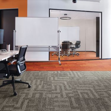 Interface Open Air 414 carpet tile with AE317 plank carpet tile in corner workstation with whiteboard and meeting room in background image number 1