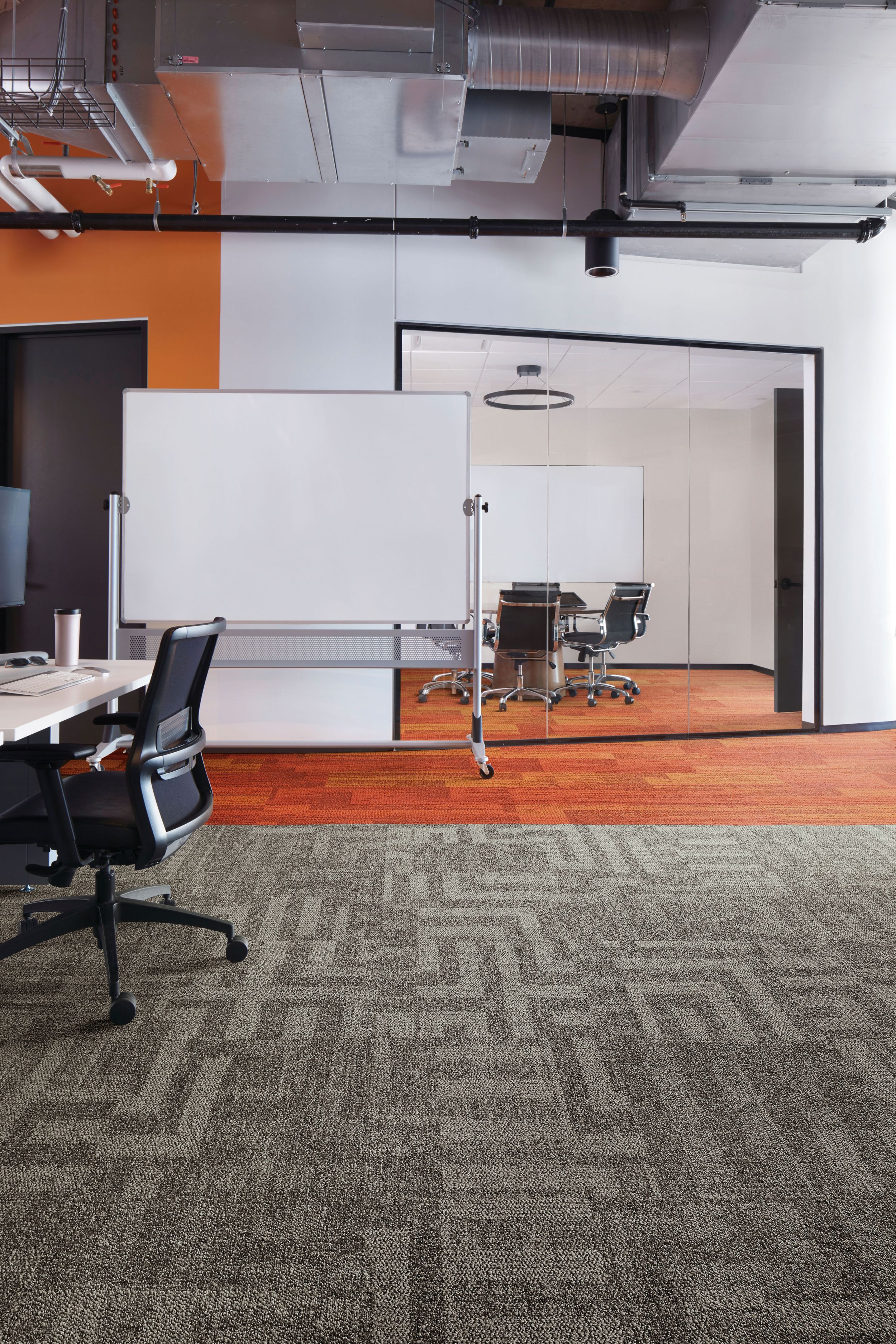 Interface Open Air 414 carpet tile with AE317 plank carpet tile in corner workstation with whiteboard and meeting room in background image number 1