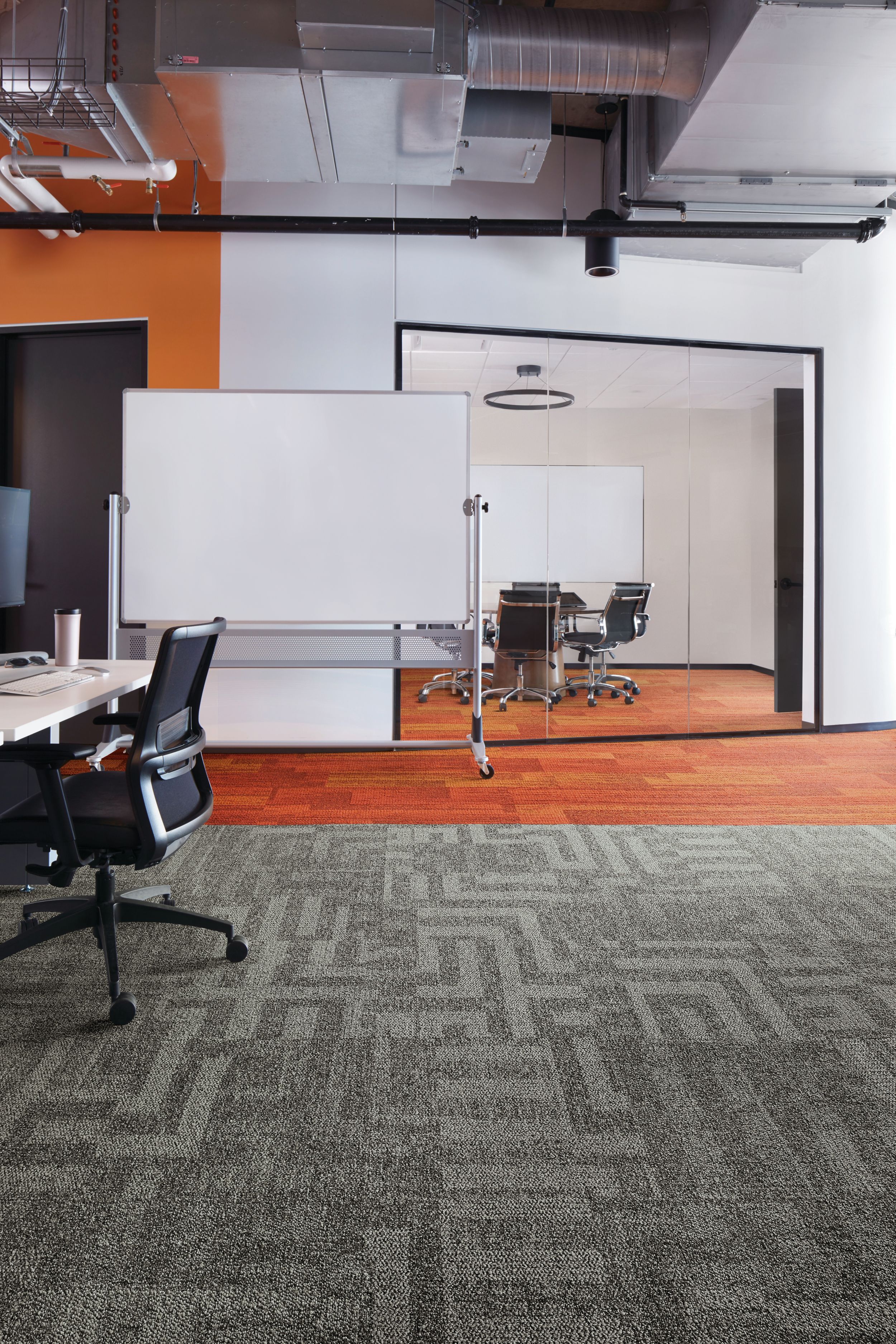 Interface Open Air 414 carpet tile with AE317 plank carpet tile in corner workstation with whiteboard and meeting room in background image number 4