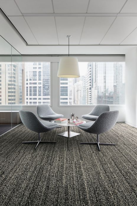 Interface Overedge plank carpet tile with fabric chairs around round table