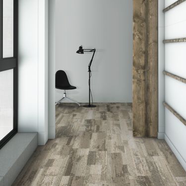 Interface Reclaim plank carpet tile in hallway with black chair and lamp