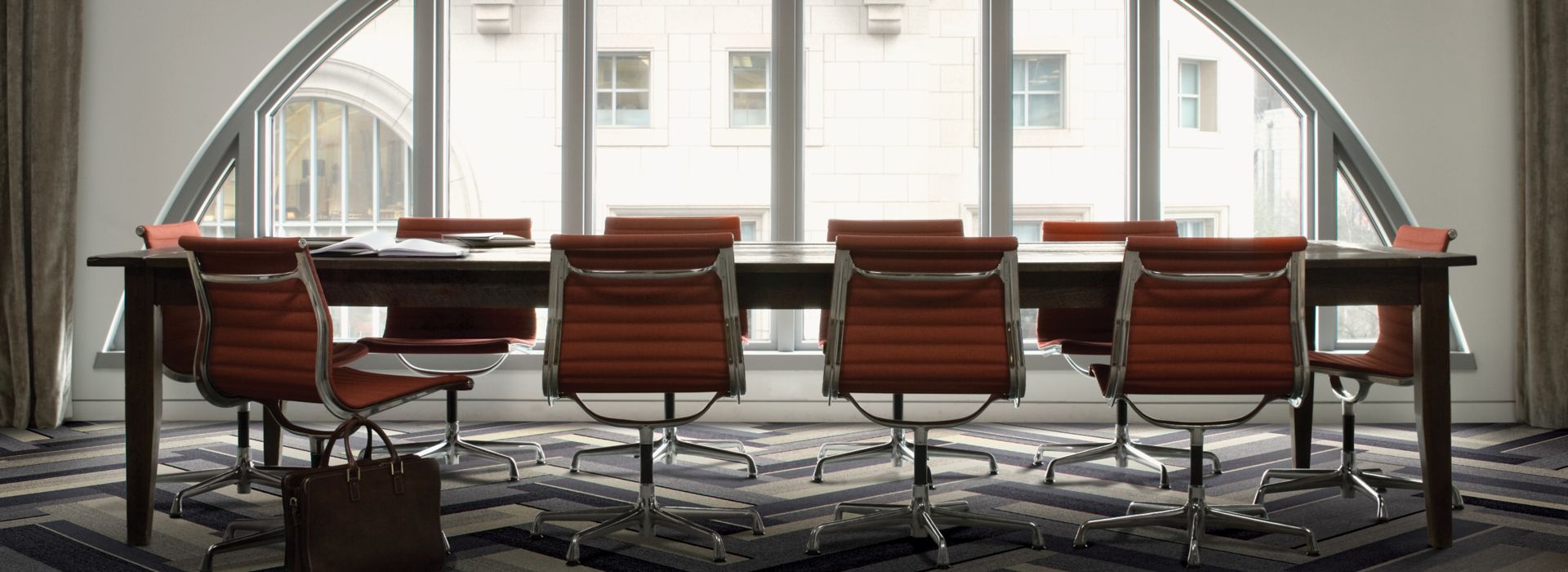 Interface PH210 plank carpet tile in naturally lighted meeting room with red chairs