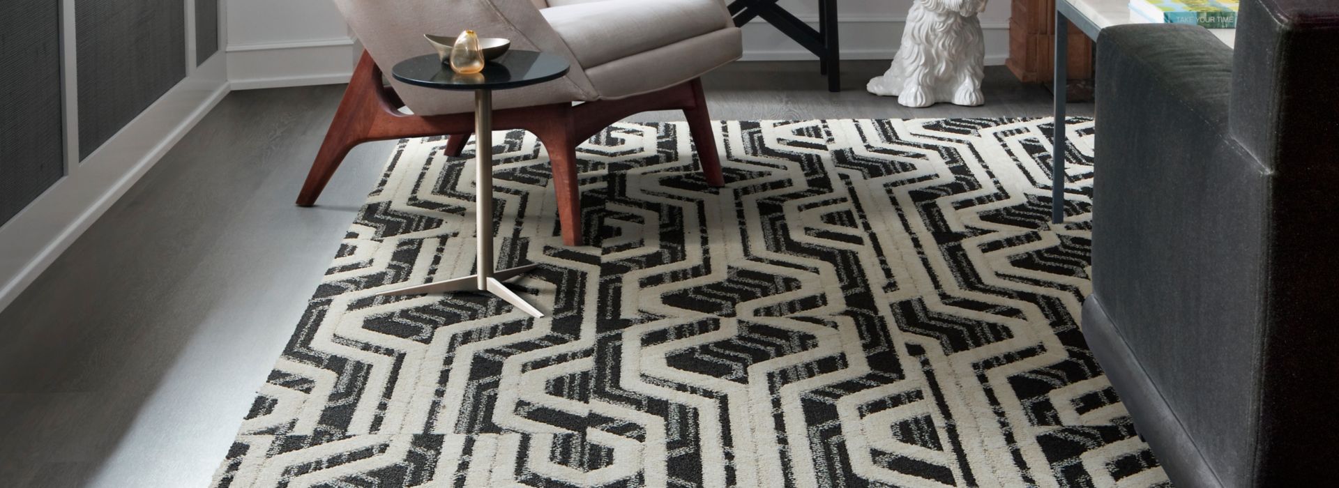 Interface PM19 plank carpet tile with Textured Woodgrains LVT in seating area with fireplace