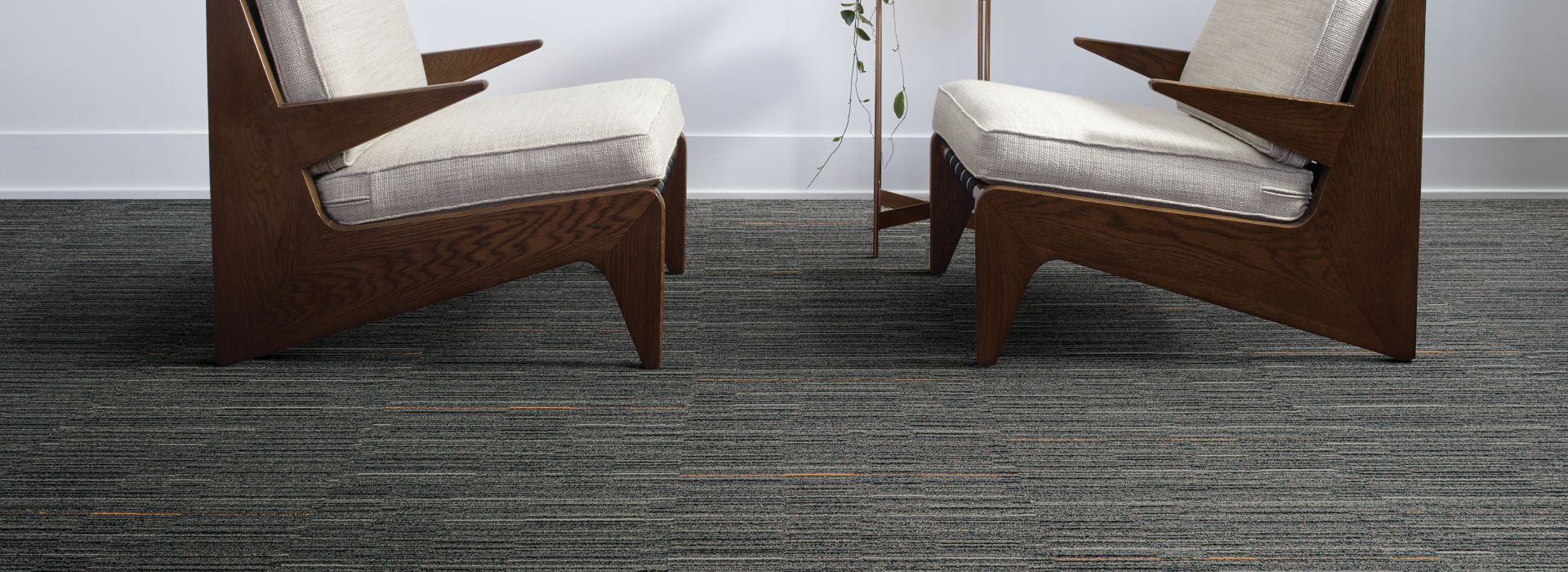 Interface Alliteration and Palindrome carpet tile in small seating area with multiple, framed prints on the wall
