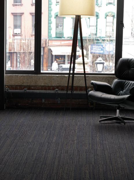 Interface Permian carpet tile in naturally lighted room with chair and lamp image number 6