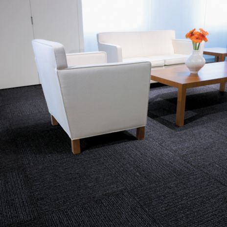 Interface Platform carpet tile in seating area with flowers on wooden table