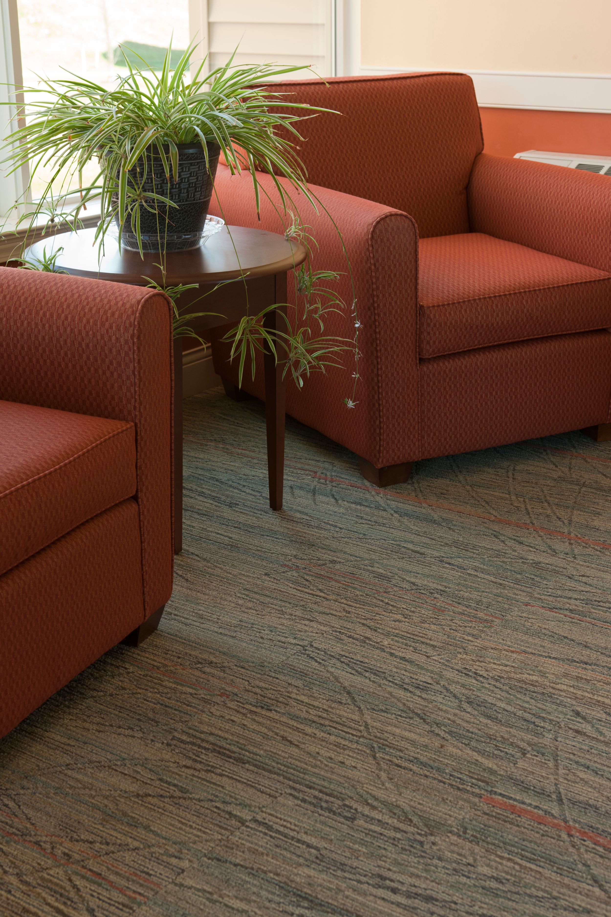 Detail of Interface Prairie Grass carpet tile in seating area with wood table and plant image number 9