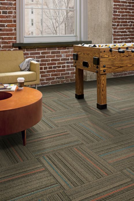 Interface Primary Stitch carpet tile in lounge area with foosball table