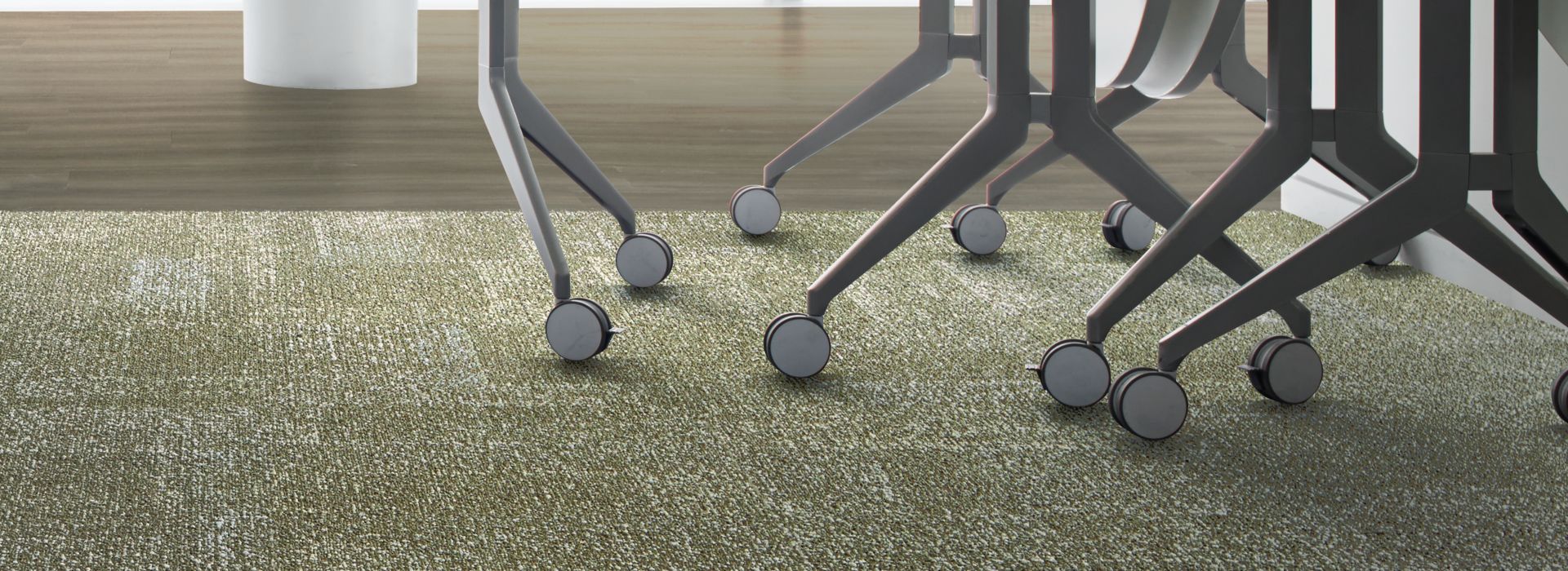 Interface Profile carpet tile and Studio Set LVT in meeting room with chairs and whiteboard