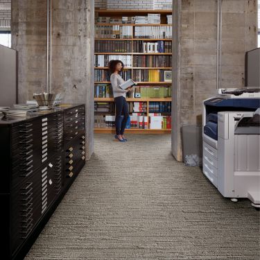 Interface Progression II plank carpet tile in office with women looking at book