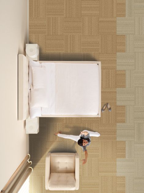 Interface RMS 103 carpet tile in hotel guest room with woman doing yoga