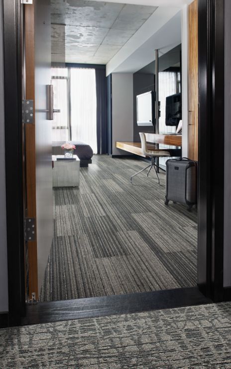 Interface RMS 509 and WE153 plank carpet tile in hotel guest room with black suitcase imagen número 1