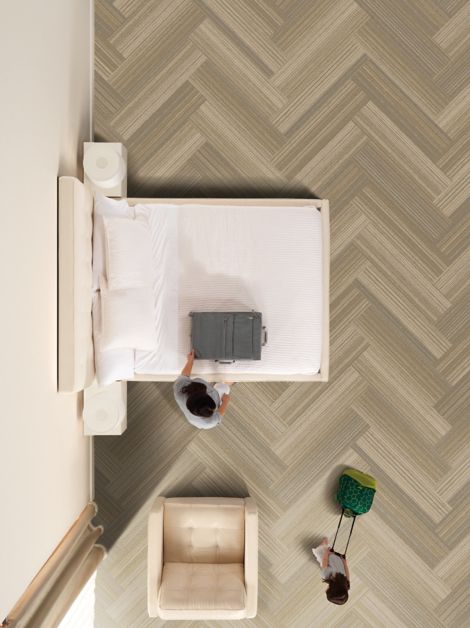 Interface RMS 509 plank carpet tile in hotel guest room with girl pulling suitcase imagen número 7