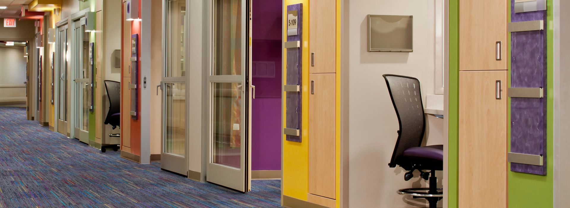 Interface Roy G Biv carpet tile in healthcare corridor with multiple rooms