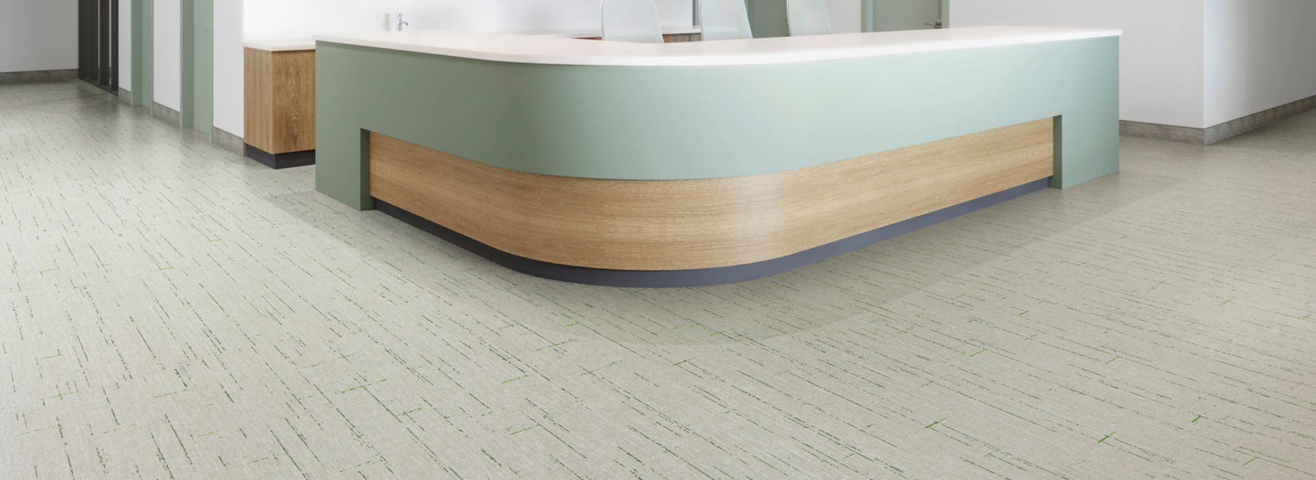 Interface Raw Materials plank LVT in Grass Green in a reception area.