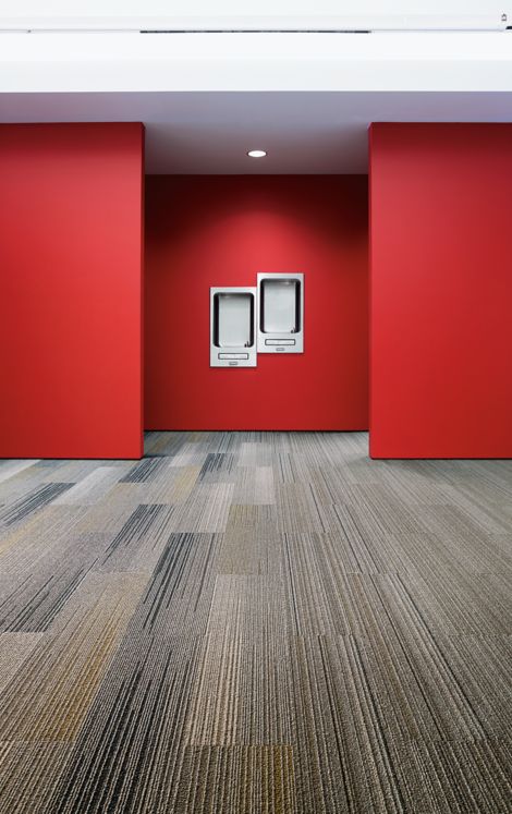 Interface SL910 and SL930 plank carpet tile in water fountain area with red walls