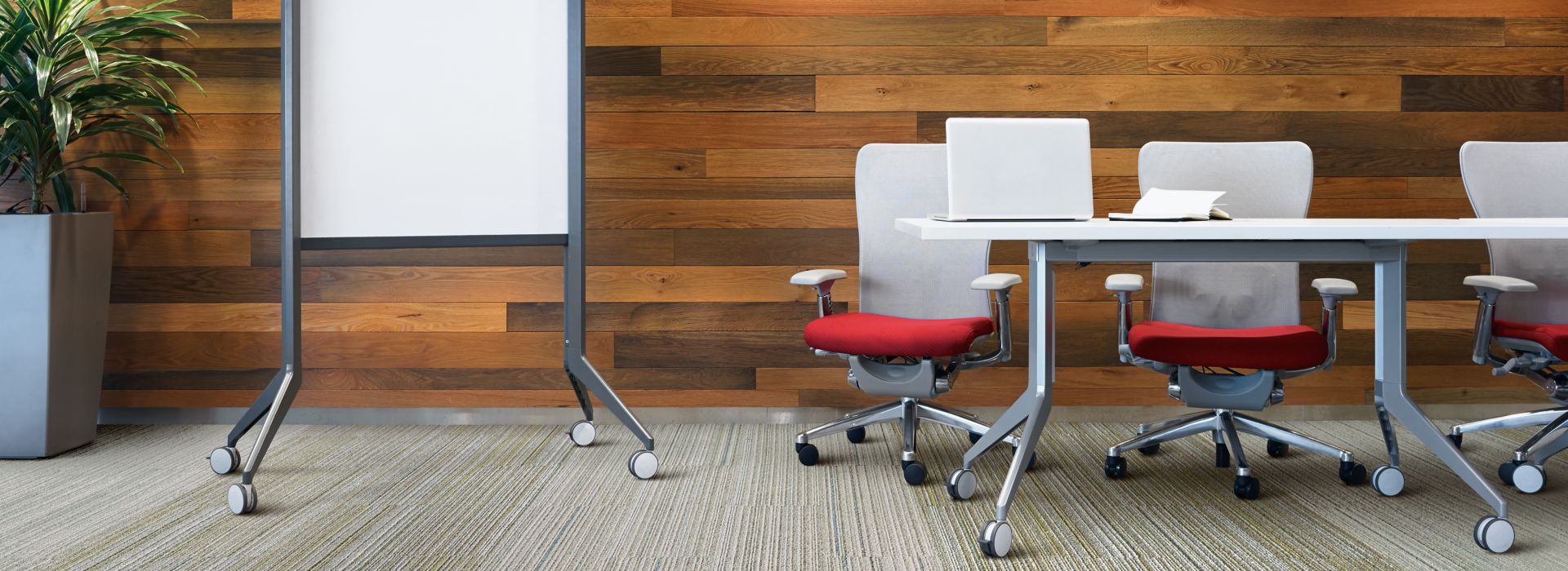 Interface SL920 plank carpet tile in meeting area with conference tables, chairs, white board and plant