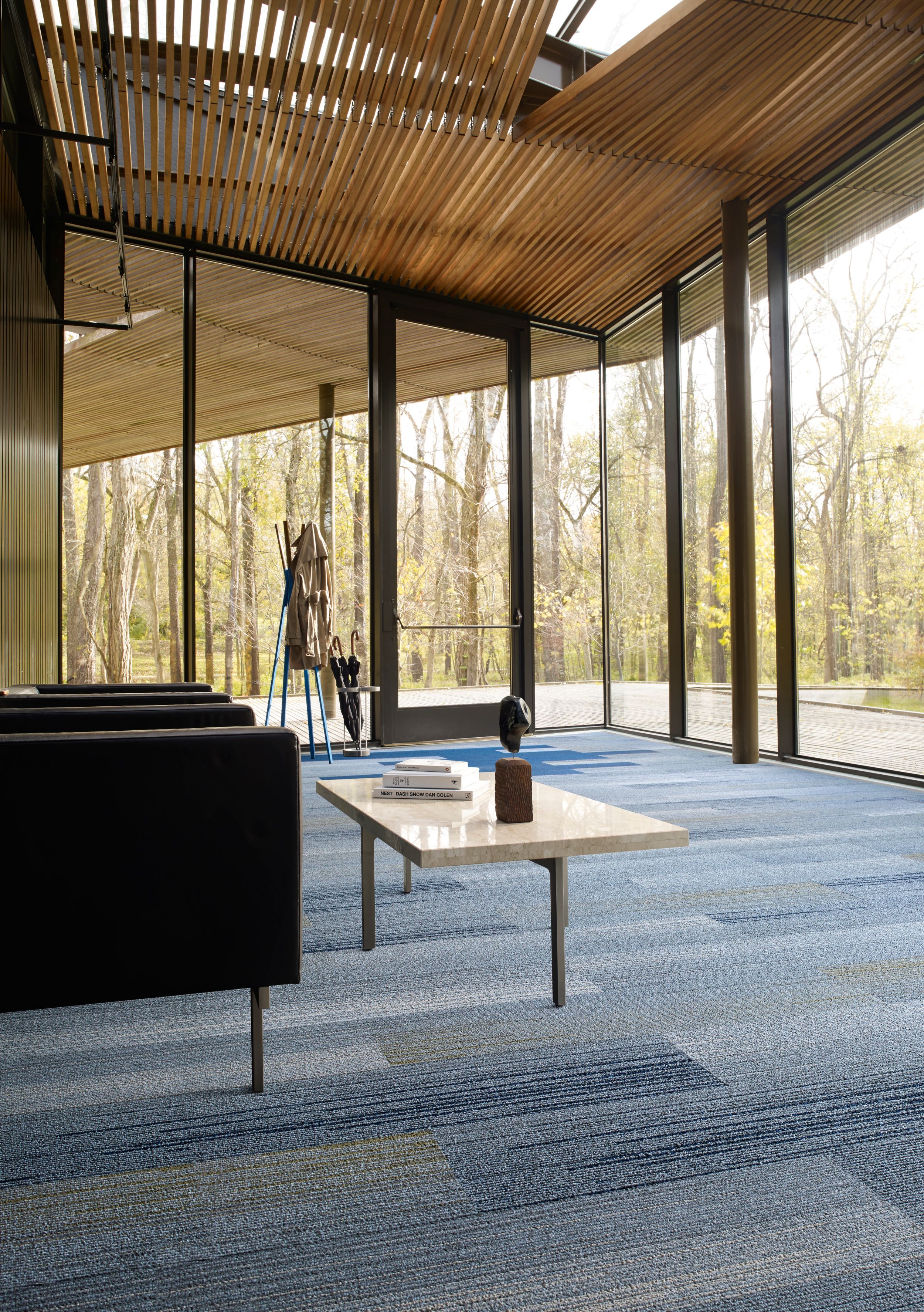 Interface SL910 and SL930 plank carpet tile in room with glass walls, wood ceiling and two chairs with table numéro d’image 6