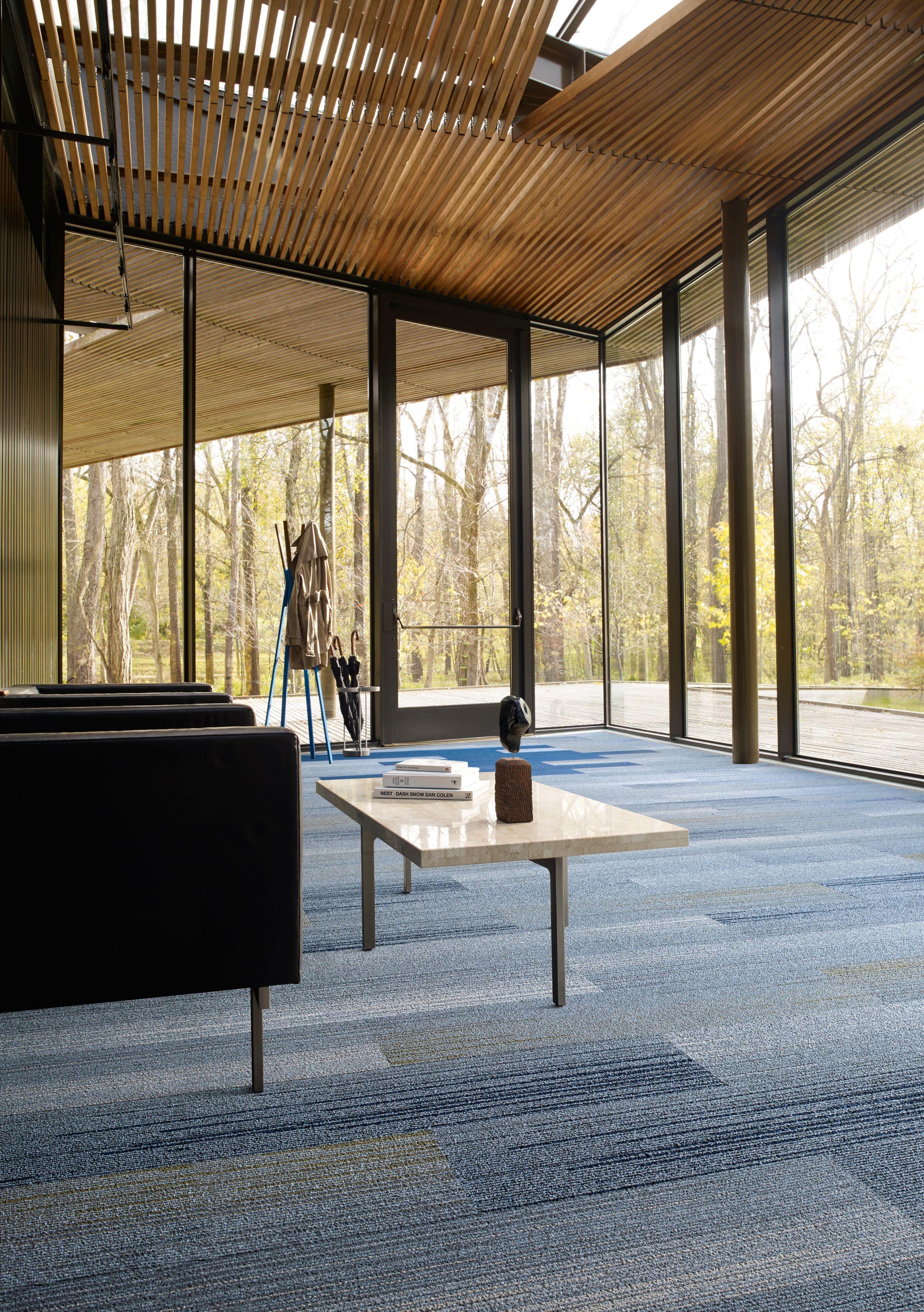 Interface SL910 and SL930 plank carpet tile in room with glass walls, wood ceiling and two chairs with table image number 6