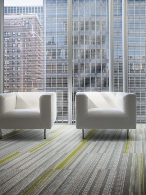 Interface SS217 and SS218 plank carpet tile in seating are with two chairs and glass walls