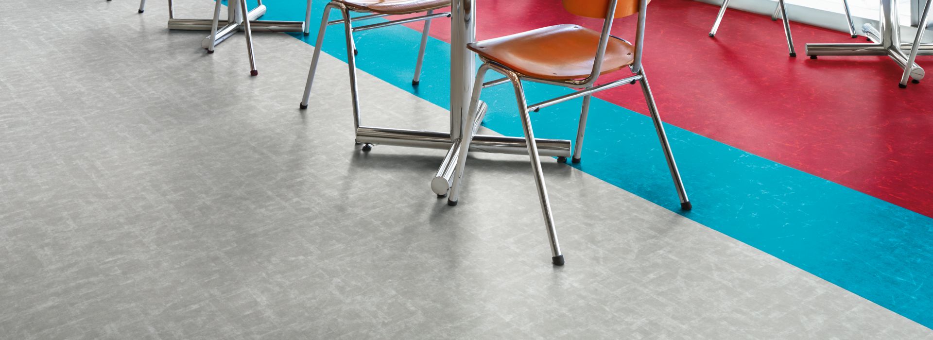 Interface Scorpio and Aries LVT in cafeteria setting with round table and chairs