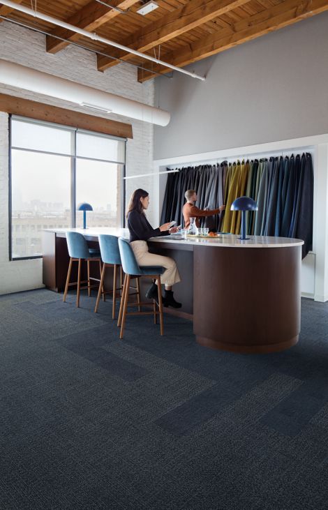 Interface Shishu Stitch and Vintage Kimono plank carpet tile in workspace with bar height table and person sitting