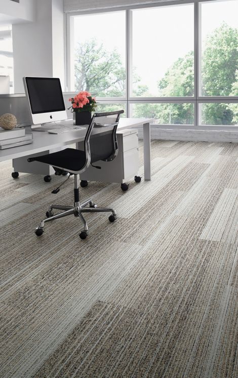 Interface Shiver Me Timbers plank carpet tile in workspace with pink flowers on desk 