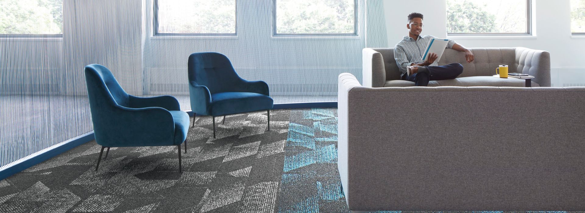 Interface Spandrel plank carpet tile in common area with couches and chairs 