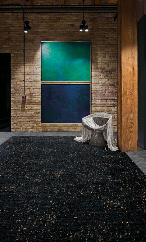 Interface Step Aside and Walk of Life carpet tile in common area with art