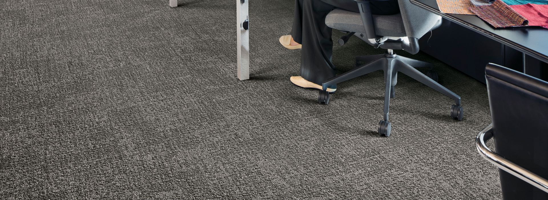 Interface Step in Time carpet tile shown with office cubicles and brick walls